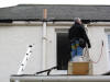 attaching a downpipe standing on The North Wing roof