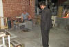 Murano craftsman giving demonstration and the 'wanna buy a horse' salesman looking on